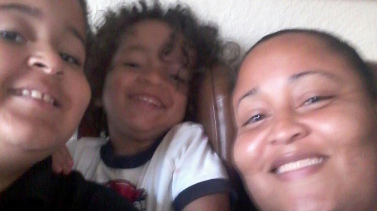 A family picture of Rosa Felipe with her sons Saiid Marte, far left, and Ishaan Marte. She is a Jackson Hospital healthcare worker who was one of the first to contract COVID-19 and remains in the hospital.