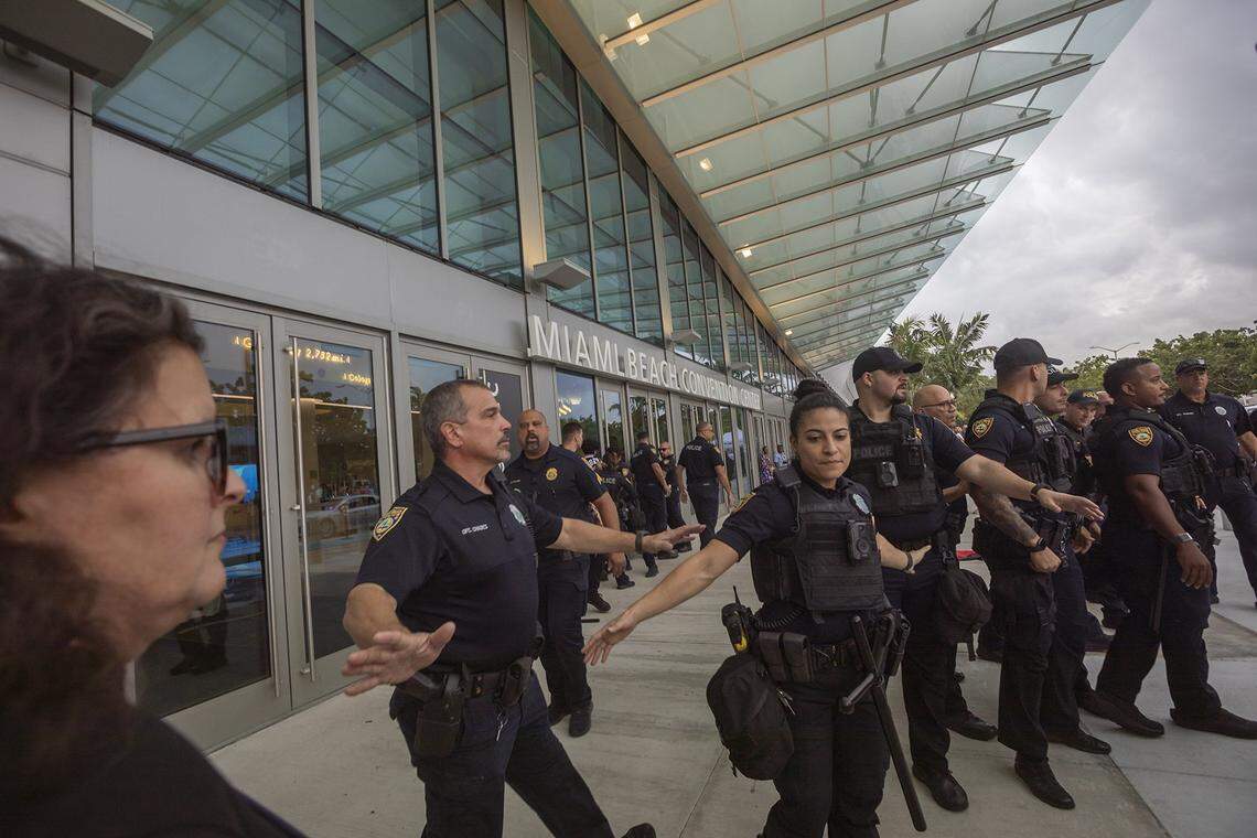 Miami Beach Police keeping pro-Palestine protesters away from the Miami Beach Convention Center doors at a protest during Art Basel.