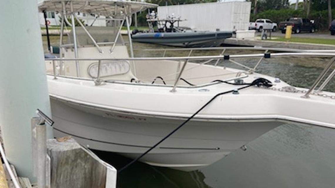 A center console boat the U.S. Coast Guard said was used to smuggle 26 people from Cuba to the United States Sunday, Jan. 23, is tied to a dock.