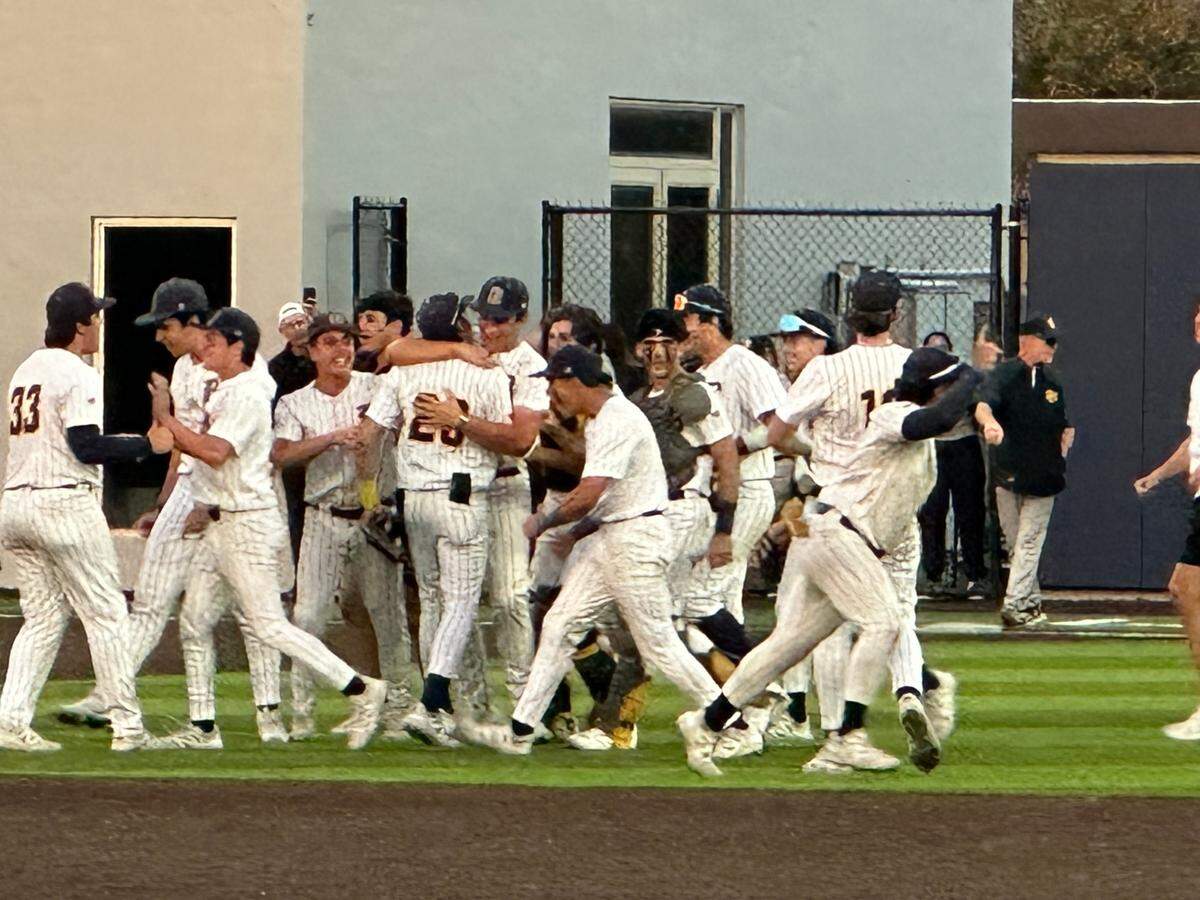 Belen Jesuit baseball players rush the field moments after the Wolverines beat Merritt Island 2-0 to clinch their Region 4-4A semifinal series 2-1.