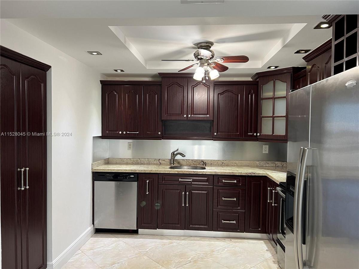 The Normandy Isles apartment has a walk-in kitchen, pictured above, with stainless steel appliances and granite countertops.