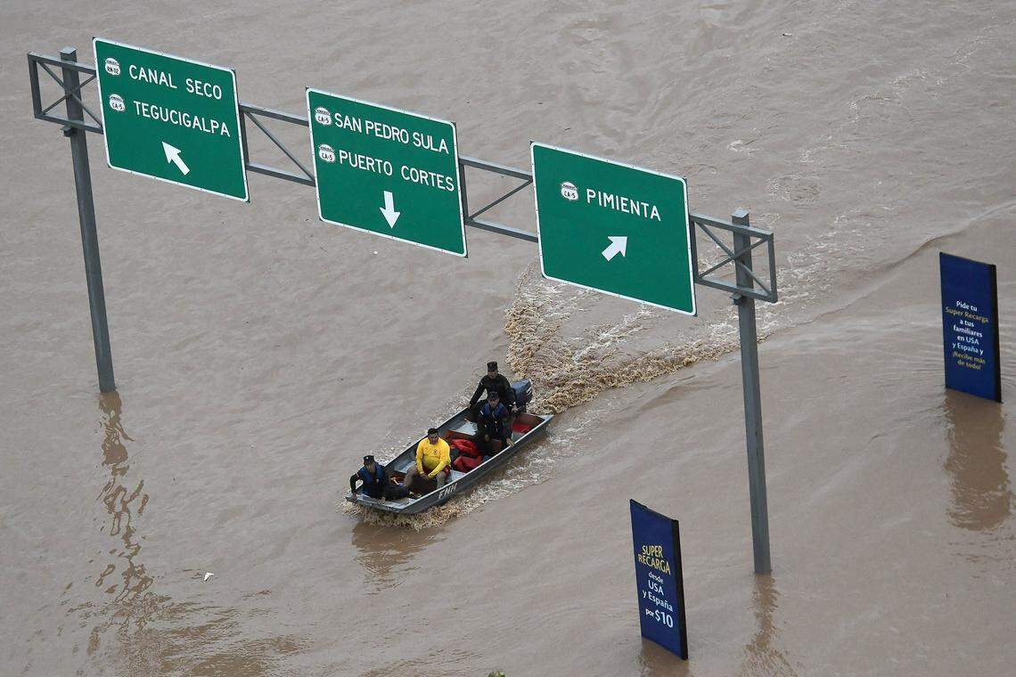 Military officers and firefighters make tours by boat in search of trapped people after tropical depression Iota unleashed floods on November 18, 2020, in Pimienta, Honduras.