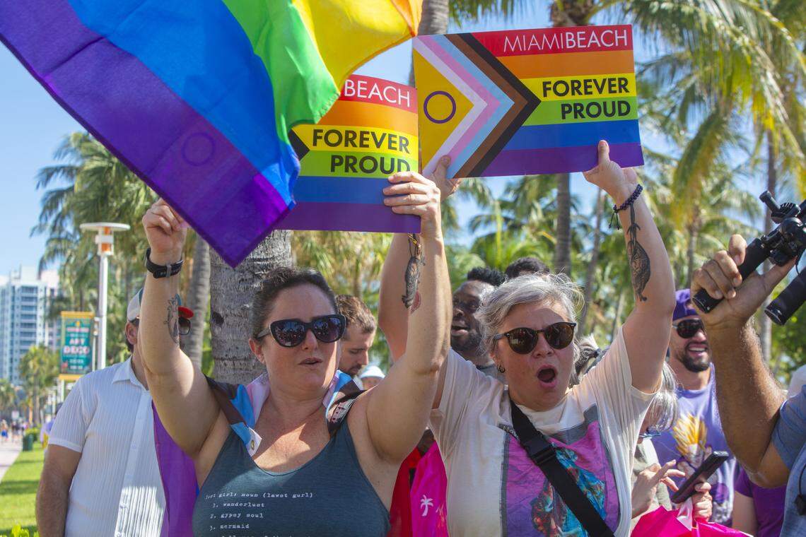 From left, Adriana May and Cynthia Ordaz rally with other demonstrators carrying rainbow flags and signs reading ‘Miami Beach Forever Proud’ and ‘Won’t Be Erased’ during the Forever Proud March on Ocean Drive in Miami Beach, Fla., Sunday, Aug. 31, 2025. The march followed state officials’ order to remove the city’s LGBTQ Pride crosswalk.