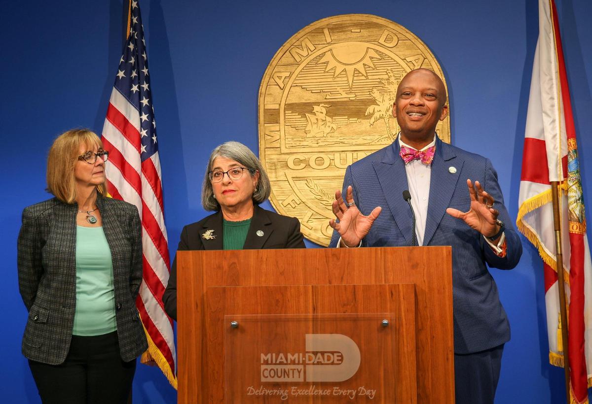 Commissioner Eileen Higgins, left, and Miami-Dade County Mayor Daniella Levine Cava, center, listen as Oliver G. Gilbert, chair of the Miami-Dade County Commission, explains proposed increases in board staffing during the county budget press conference at the Stephen P. Clark Government Center on Monday, July 17, 2023.