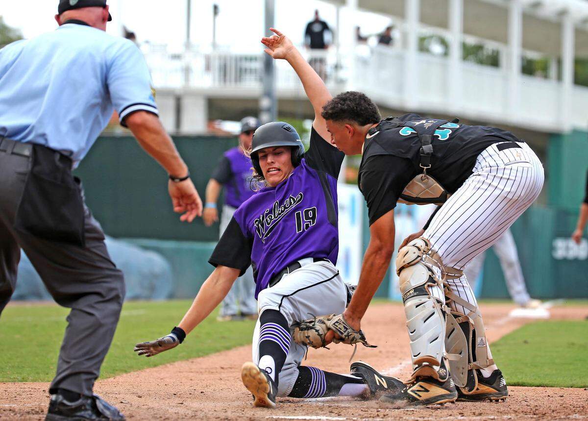 Coral Reef HS catcher Sebastian Jimenez (2) tags out Timber Creek HS Andrew Spolyar (19) in the FHSAA Semi-Final Class 9A Division at CenturyLink Sports Complex - Hammond Stadium in Fort Myers, Florida, Thursday, May, 30, 2019. Coral Reef won 7-4.