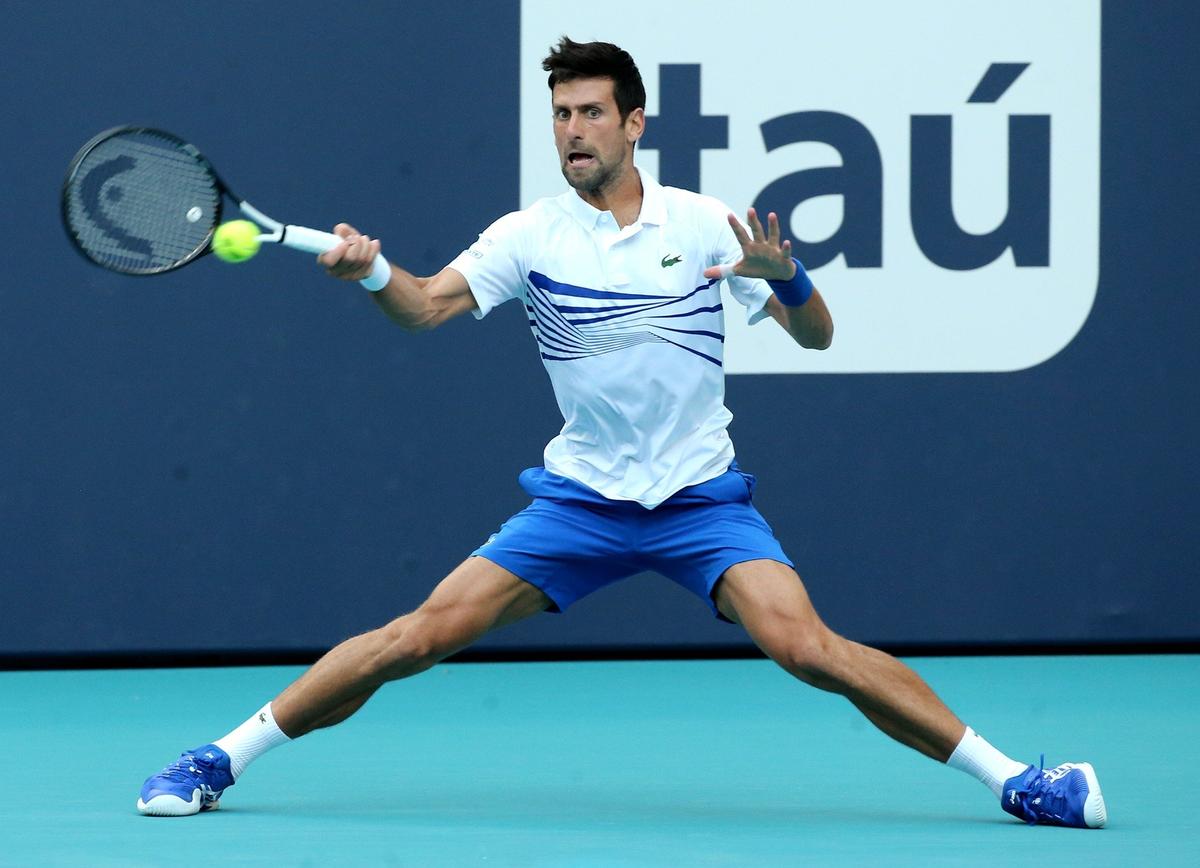 Novak Djokovic returns a ball to Fererico Delbonis at the 2019 Miami Open at Hard Rock Stadium in Miami Gardens, Florida, Sunday, March, 24, 2019.