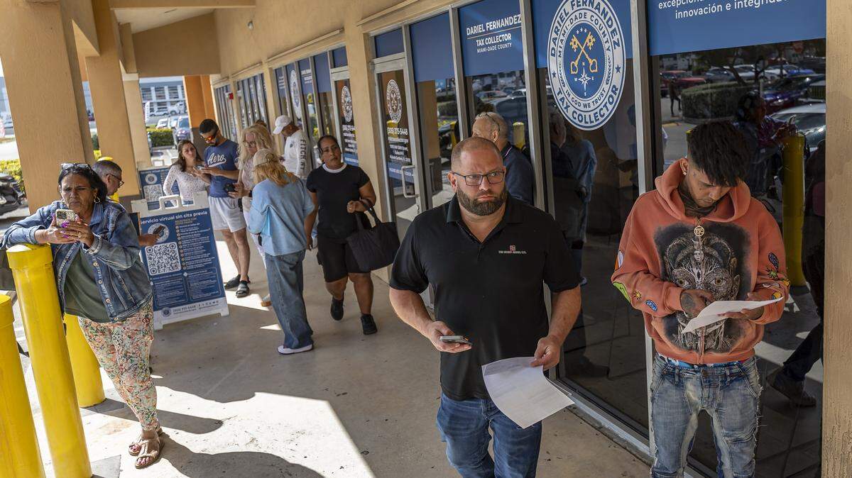 People wait outside a driver license office for their appointments on Tuesday, Feb. 10, 2026, in Hialeah Gardens, Fla. As of Feb. 6, 2026, the Florida Department of Highway Safety and Motor Vehicles requires all driver license knowledge and skills examinations to be conducted exclusively in English.