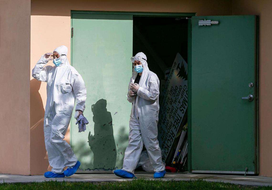 Workers outside a monoclonal antibody treatment site for COVID-19 at Markham Park in Sunrise, Florida, on January 19, 2022.