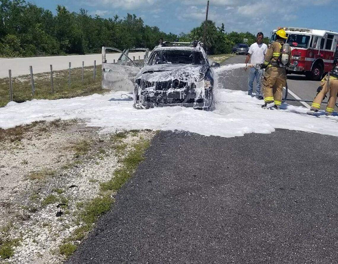 Monroe County emergency workers put out a vehicle fire on U.S. 1 in the Lower Keys on Wednesday, May 22, 2019.
