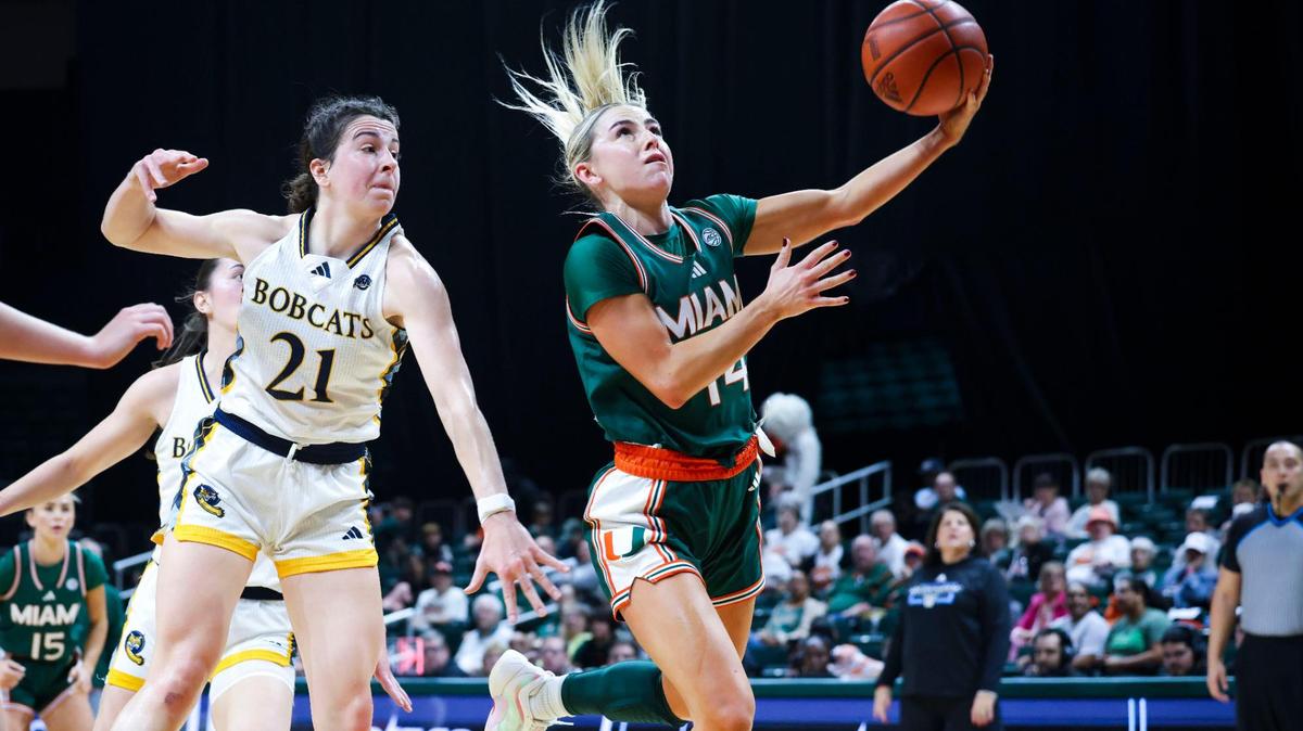 Miami Hurricanes Haley Cavinder(14) shoos a layup around Quinnipiac Bobcats Jackie Grisdale (21) during the second quarter of the game on Sunday, Dec. 1, 2024, at Watsco Center in Coral Gables, Fla.