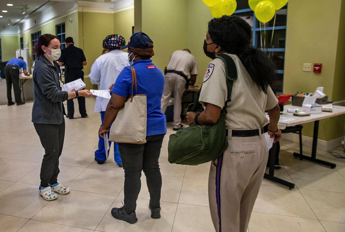Miami Jewish Health employees line up to be screened and tested for COVID-19 before starting their shifts on Aug. 19, 2021. As the pandemic surges in Florida and elsewhere, nursing homes are once again limiting visitors and setting new rules to control spread of the disease in their facilities.