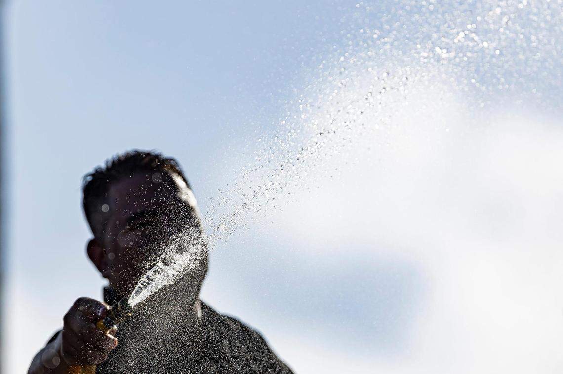 Andres Martinez cleans the Schwartz Center for Athletic Excellence at the University of Miami on Tuesday, Aug. 8, 2023, in Coral Gables, Fla. The National Weather Service has issued an excessive heat advisory Tuesday in parts of Florida.