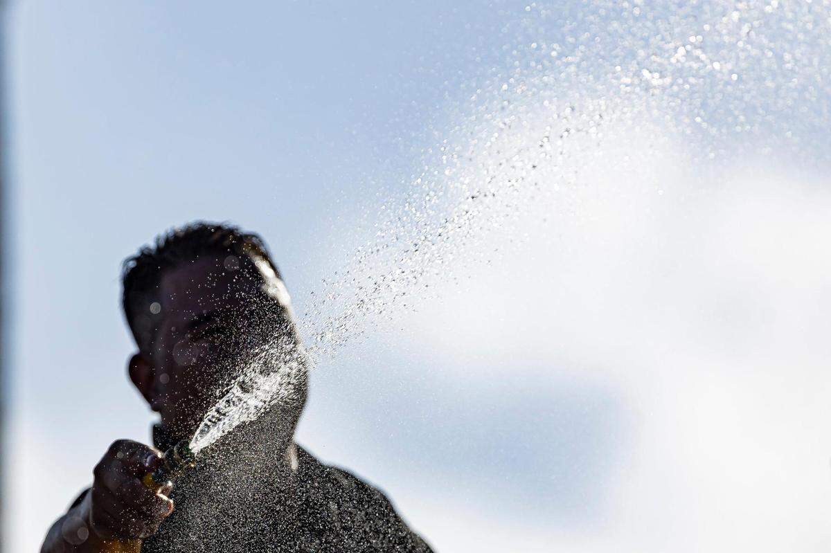 Andres Martinez cleans the Schwartz Center for Athletic Excellence at the University of Miami on Tuesday, Aug. 8, 2023, in Coral Gables, Fla. The National Weather Service has issued an excessive heat advisory Tuesday in parts of Florida.