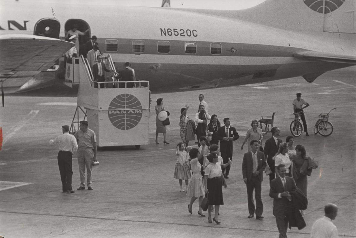 People deplane at the Miami airport in 1962 after waiting for their flight.