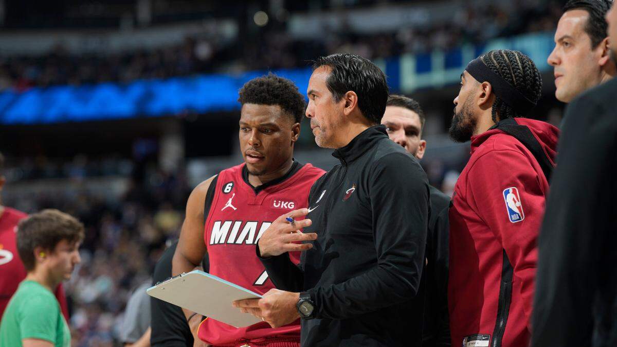 Miami Heat head coach Erik Spoelstra confers with guard Kyle Lowry in the second half of an NBA basketball game Friday, Dec. 30, 2022, in Denver.
