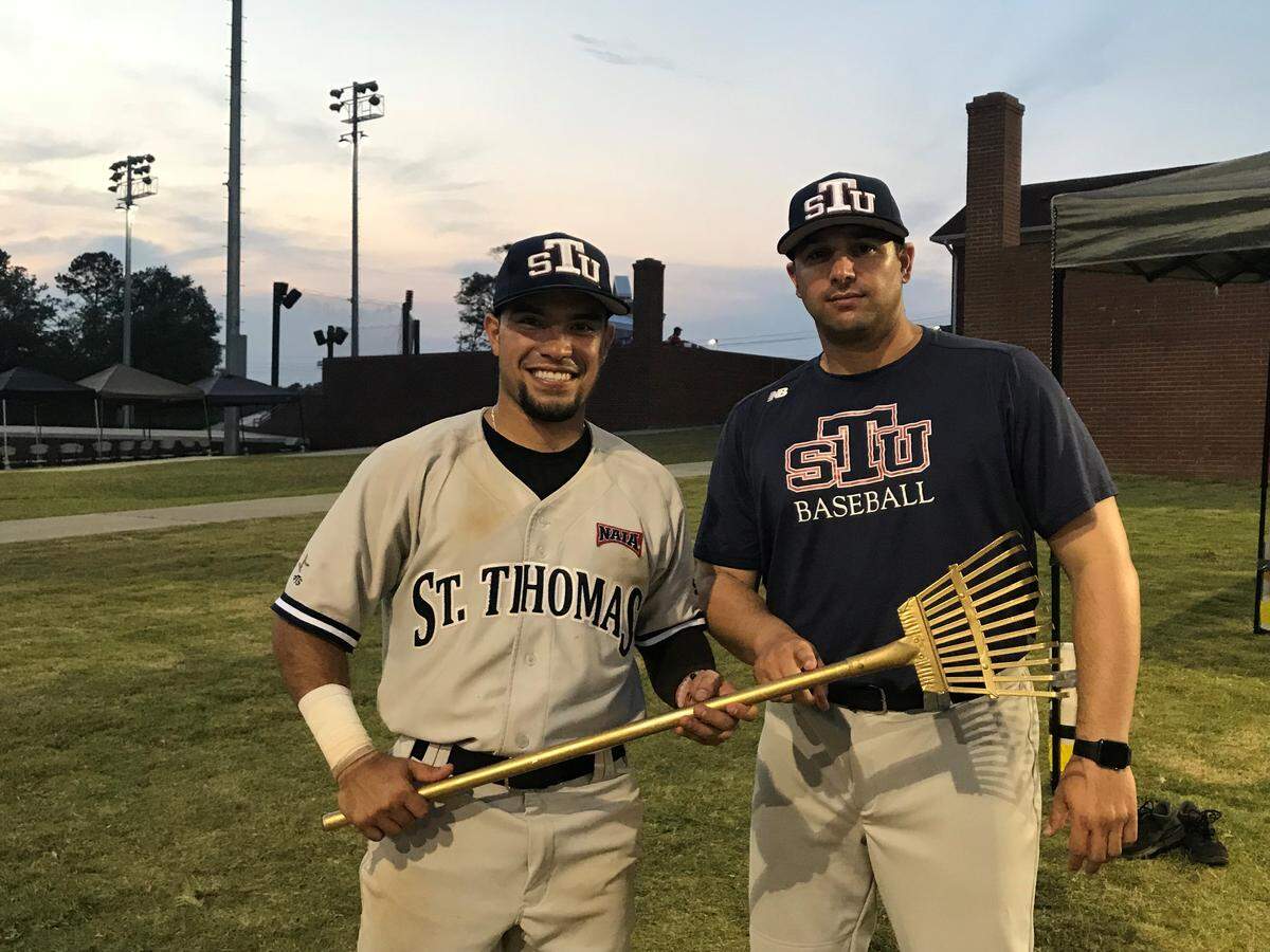 St. Thomas University shortstop Erick Delgado won the most recent Golden Rake with a  two-run home run that proved the difference in the Opening Round Championship Game. At right, assistant coach JC Gutierrez.