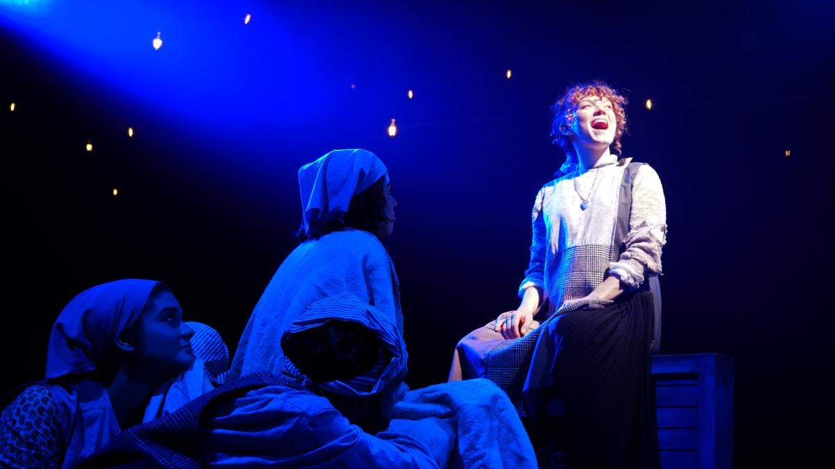 Staci Stout as the orphaned Annie sings the yearning song “Maybe” in Area Stage’s “Annie.”