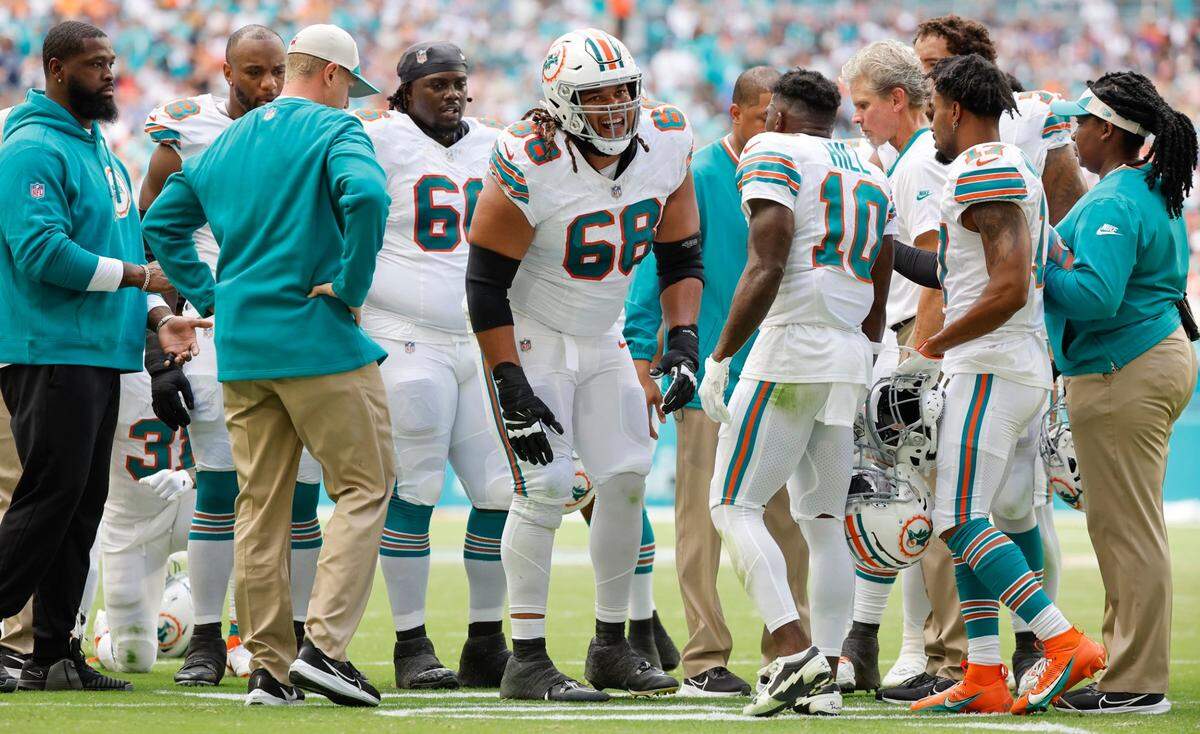 Miami Dolphins offensive tackle Robert Hunt (68) is slow to get up as medical and teammates check on him after a play in the first half against the New England Patriots at Hard Rock Stadium in Miami Gardens on Sunday, October 29, 2023.