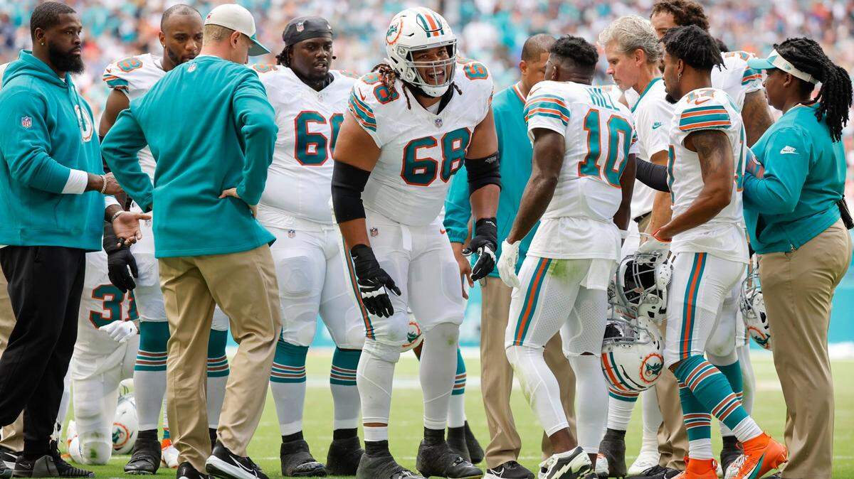 Miami Dolphins offensive tackle Robert Hunt (68) is slow to get up as medical and teammates check on him after a play in the first half against the New England Patriots at Hard Rock Stadium in Miami Gardens on Sunday, October 29, 2023.