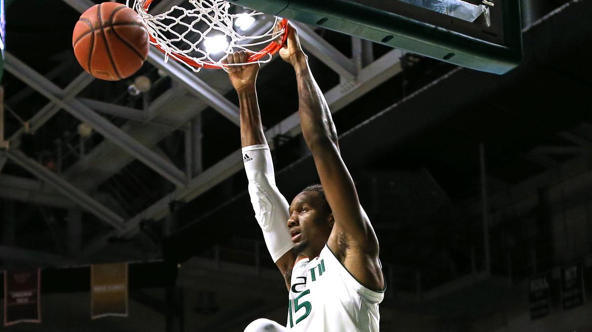 Miami Hurricanes center Ebuka Izundu (15) dunks against Notre Dame Fighting Irish forward John Mooney (33) and D.J. Harvey (5) during the first half of an NCAA college basketball game at the Watsco Center in Coral Gables on Wednesday, February 6, 2019.