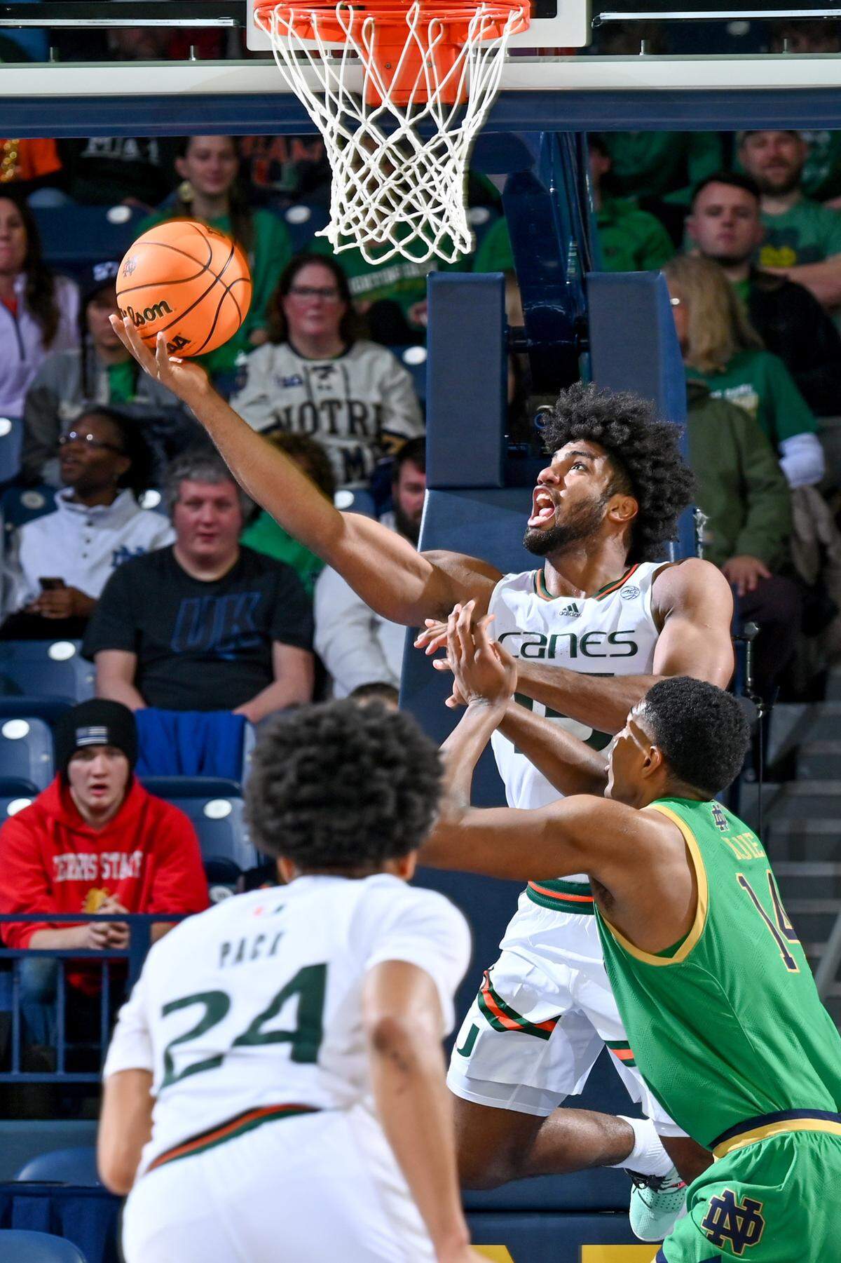 Jan 24, 2024; South Bend, Indiana, USA; Miami Hurricanes forward Norchad Omier (15) goes up for a shot as Notre Dame Fighting Irish forward Kebba Njie (14) defends in the first half at the Purcell Pavilion. Mandatory Credit: Matt Cashore-USA TODAY Sports