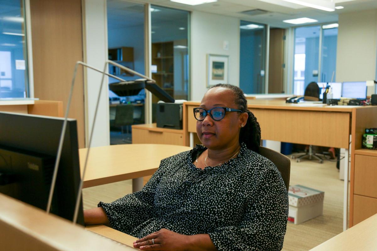 Thirty-two companies expanded to Miami-Dade County through May this year. Above: Daphney Charlemagne, a practice coordinator at Winston & Strawn, works from her desk June 10, 2022 at the law firm’s office that opened in May in downtown Miami.