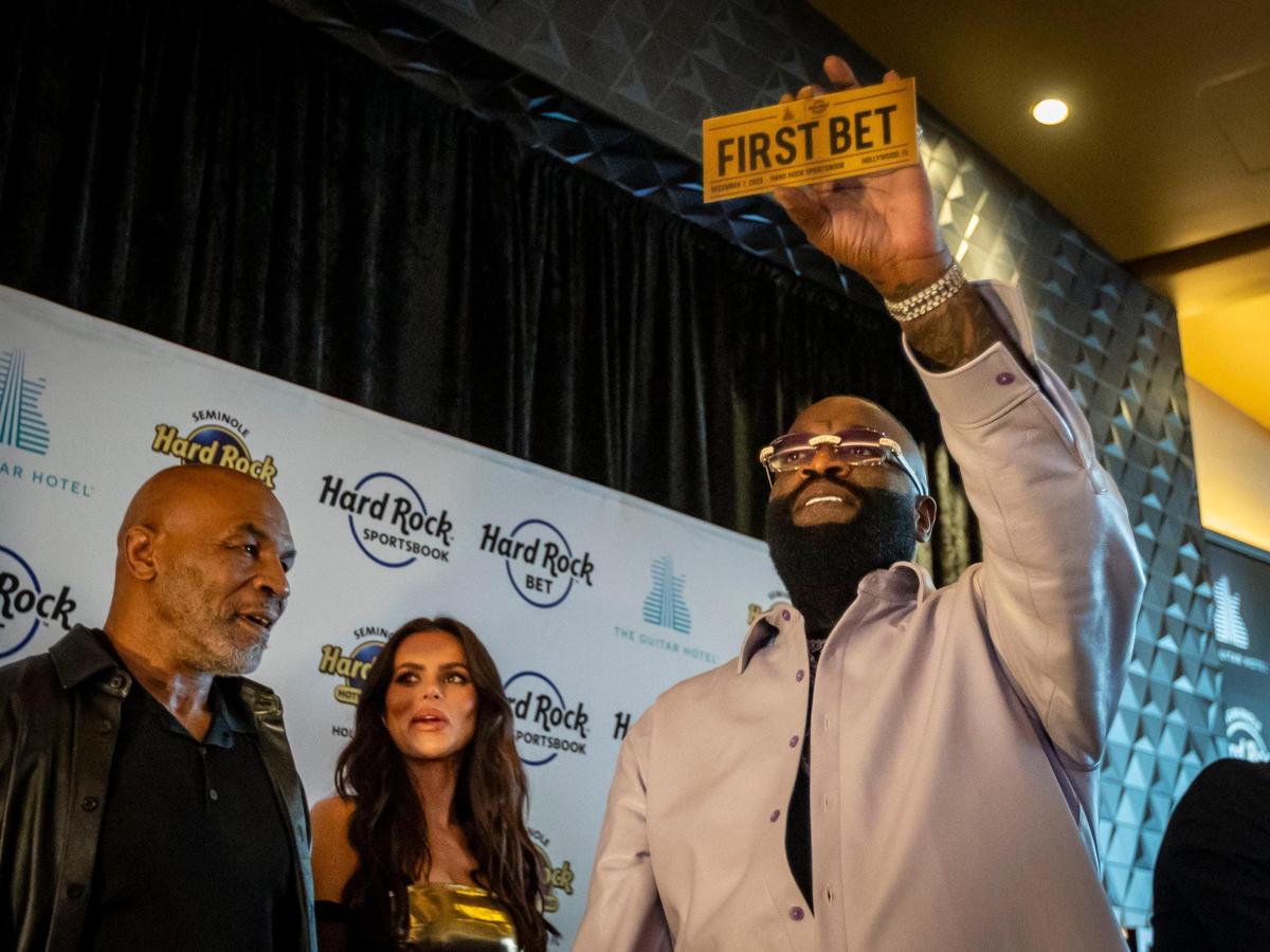 Rapper Rick Ross holds up a First Bet ticket during the table games and sports betting launch event at the Seminole Hard Rock Hotel & Casino Hollywood, on Thursday, December 7, 2023.