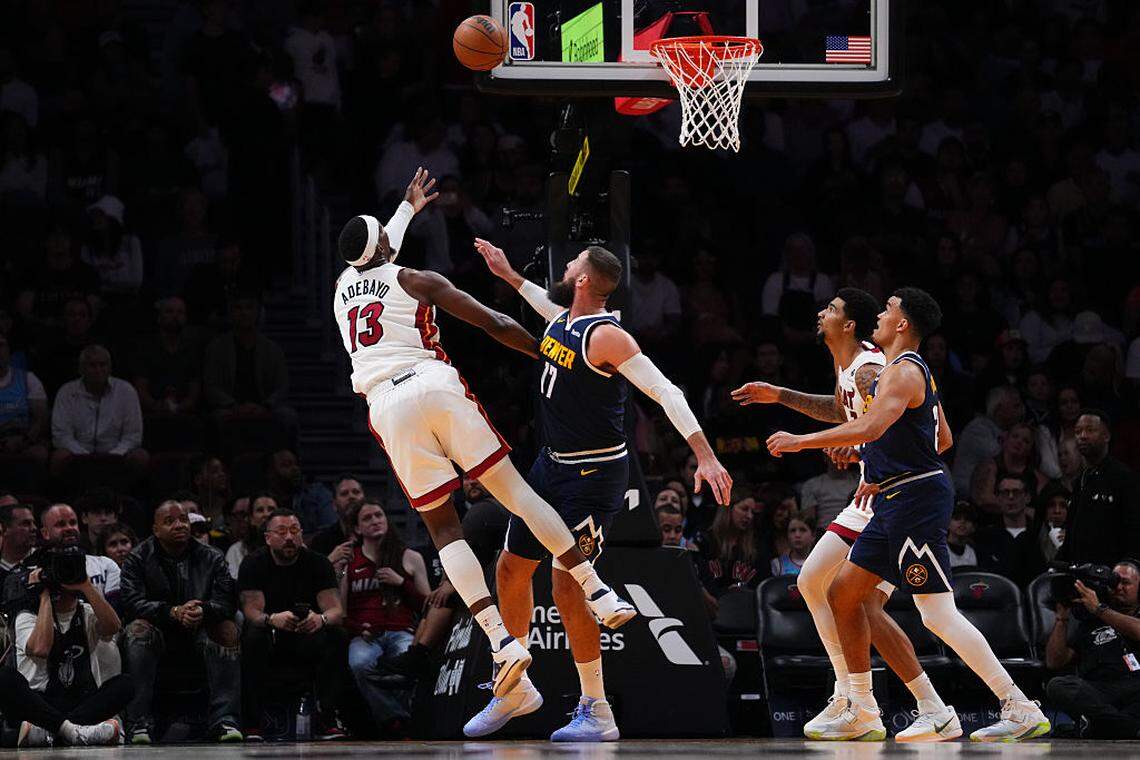 Bam Adebayo #13 of the Miami Heat goes up for a shot against Jonas Valanciunas #17 of the Denver Nuggets during the third quarter at Kaseya Center on December 29, 2025 in Miami.