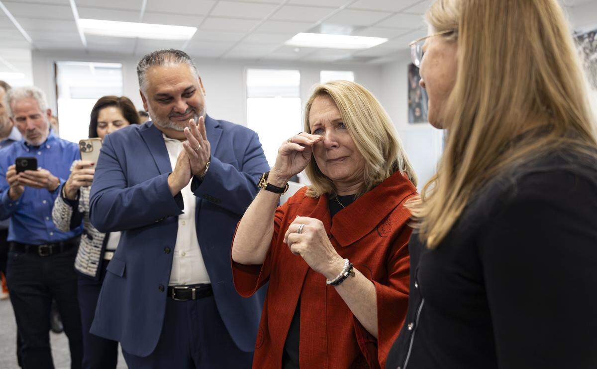 From left to right: Miami Herald Executive Editor Alex Mena, Investigative Reporter Julie K. Brown, and former Miami Herald Photojournalist Emily Michot celebrate after winning a Special Citation Pulitzer at the Miami Herald, el Nuevo Herald on Monday, May 4, 2026, in Miami, Fla. Brown was honored for her investigation, Pervasion of Justice, focusing on Jeffrey Epstein. 