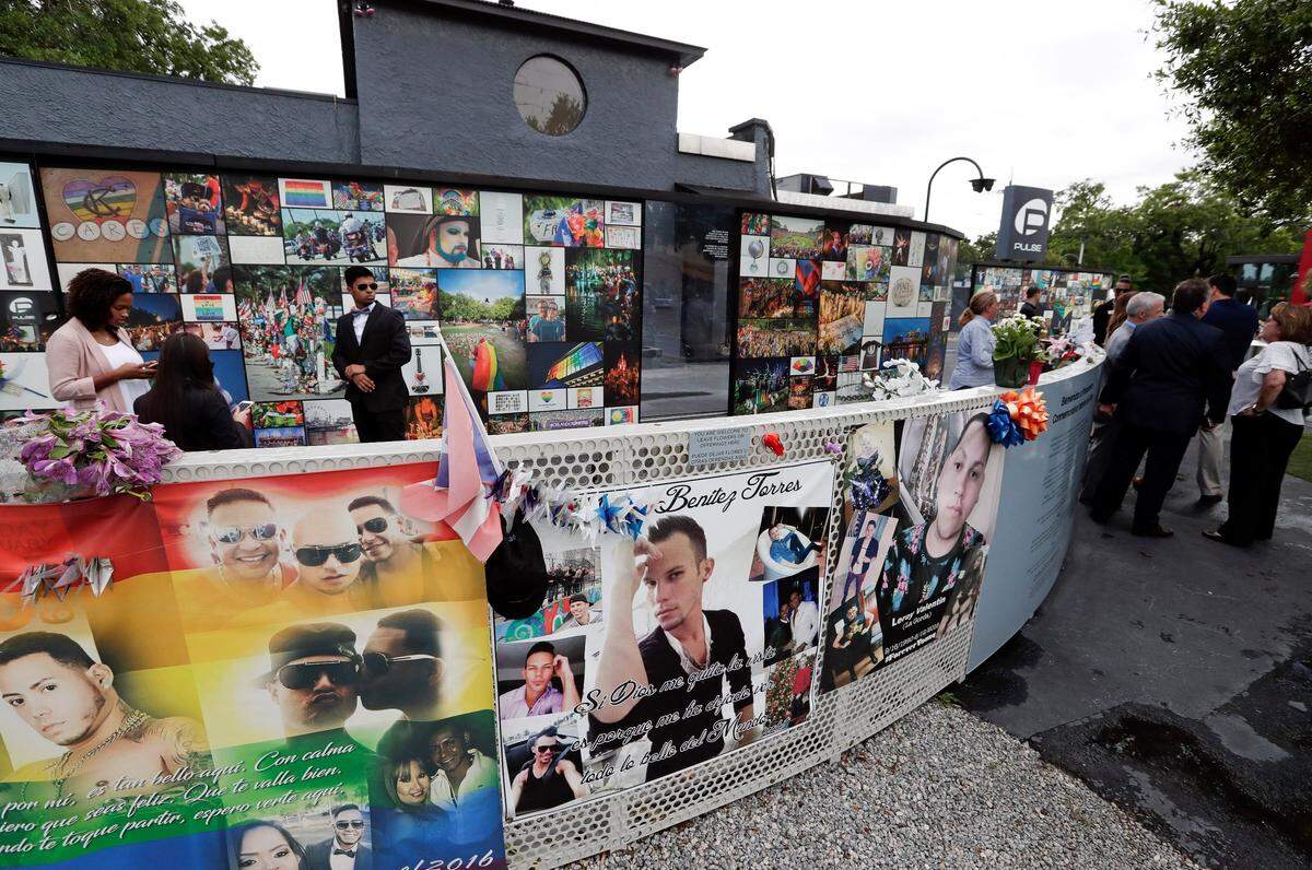People gather at the Pulse nightclub before a news conference to introduce legislation that would designate the site as a national memorial, Monday, June 10, 2019, in Orlando.