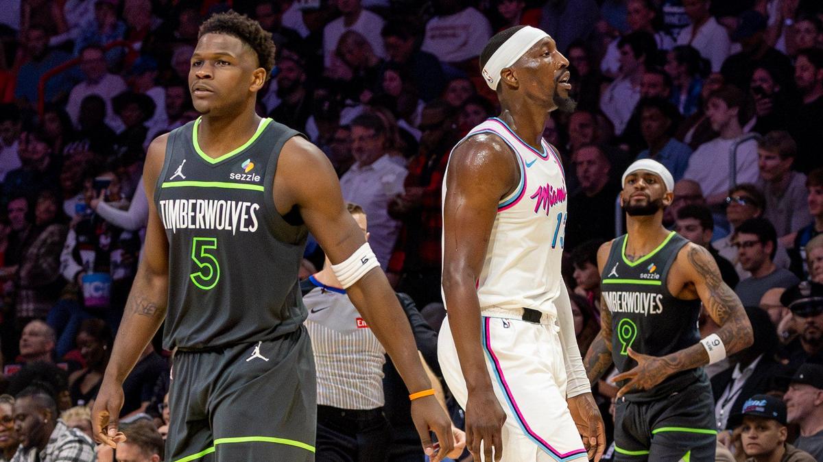 Minnesota Timberwolves guard Anthony Edwards (5) looks on as Miami Heat center Bam Adebayo (13) heads to the bench during a timeout in the second half of their NBA game at Kaseya Center on March 7, 2025, in Miami.