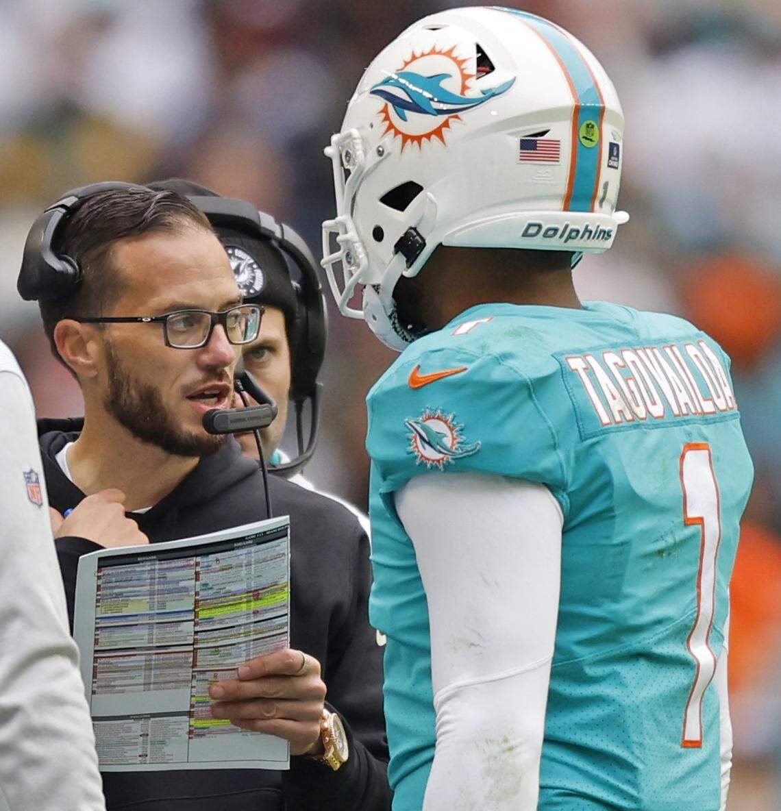 Miami Dolphins head coach Mike McDaniel talks with Miami Dolphins quarterback Tua Tagovailoa (1) in the second quarter during the game against the Green Bay Packers at Hard Rock Stadium in Miami Gardens, Florida on Sunday, December 25, 2022.