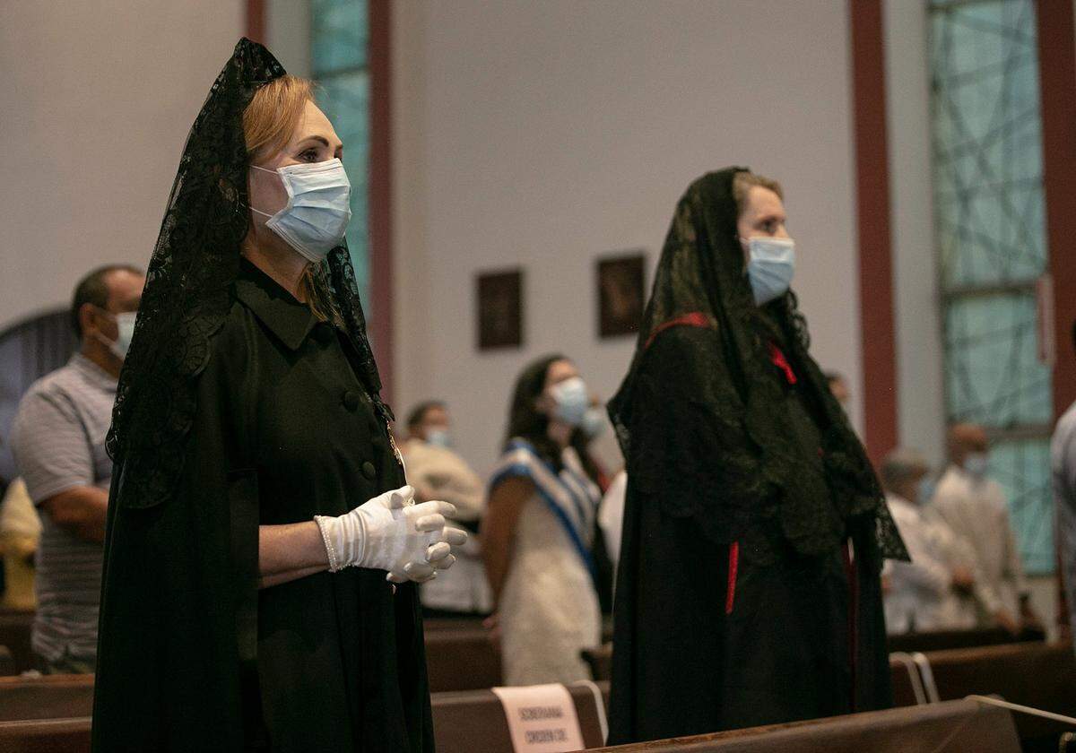 Catholic parishioners who are members of The Sovereign Military Order of Malta attended a Mass to celebrate La Virgen de la Caridad del Cobre - Our Lady of Charity of El Cobre at St. Michael the Archangel Catholic Church, wearing masks and socially distanced in the pews, Sept. 8, 2020.