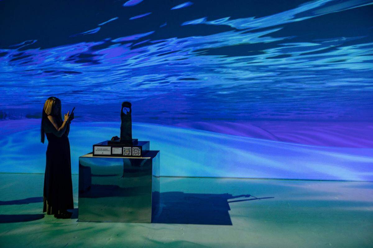 Guests interact with the exhibit SURREAL 360: A Salvador Dali Experience, on display at the Ice Palace in Miami.