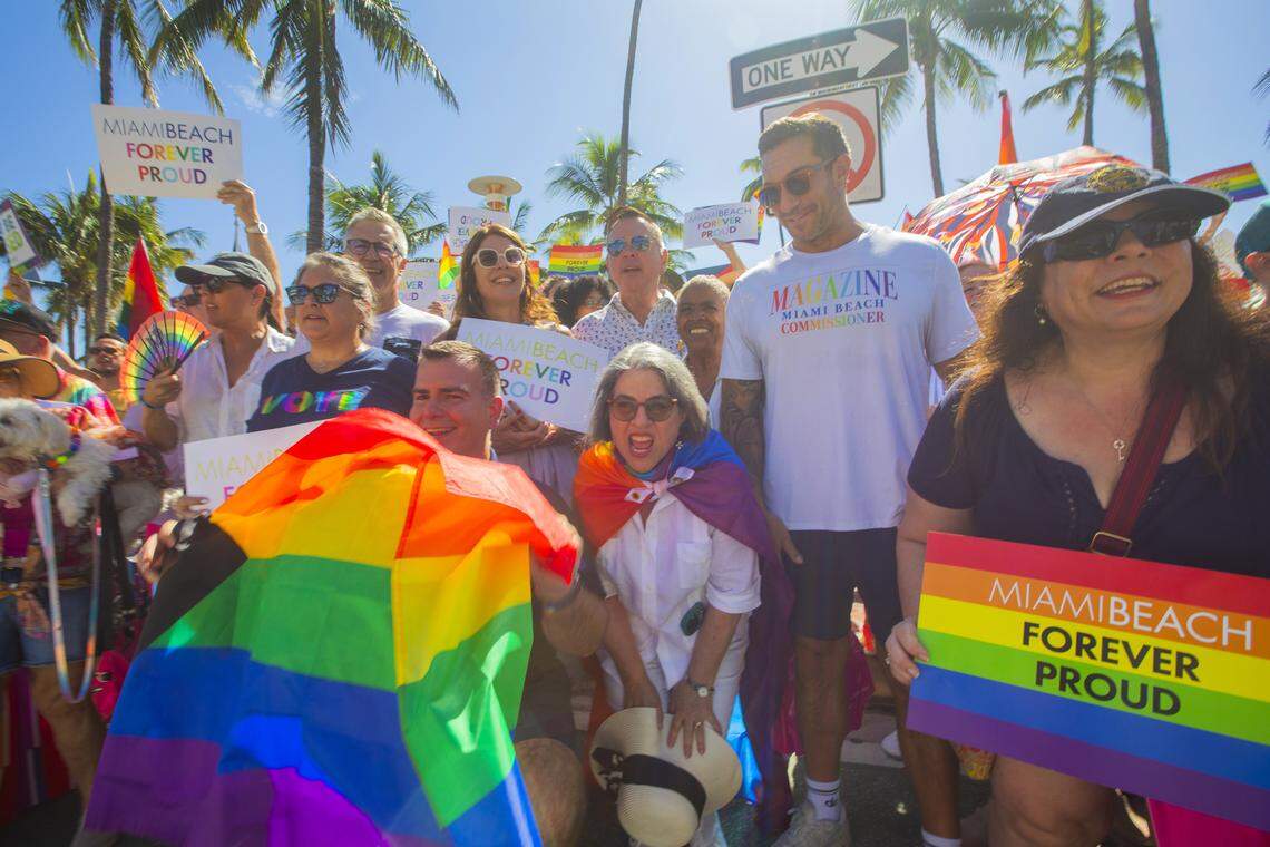 Miami-Dade County Mayor Daniella Levine Cava and Miami Beach City Commissioner Alex Fernandez wave flags alongside demonstrators carrying rainbow banners and signs reading ‘Miami Beach Forever Proud’ and ‘Won’t Be Erased’ during the Forever Proud March on Ocean Drive in Miami Beach, Fla., Sunday, Aug. 31, 2025, held after state officials ordered the removal of the city’s LGBTQ Pride crosswalk.