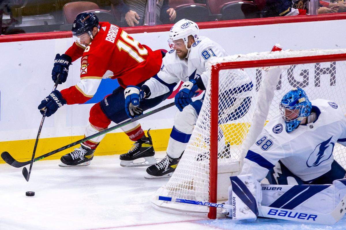 Florida Panthers center Aleksander Barkov (16) comes around the crease while guarded by Tampa Bay Lightning defender Erik Cernak (81) during a NHL preseason game at FLA Live Arena in Sunrise, Florida, on Thursday, October 6, 2022.