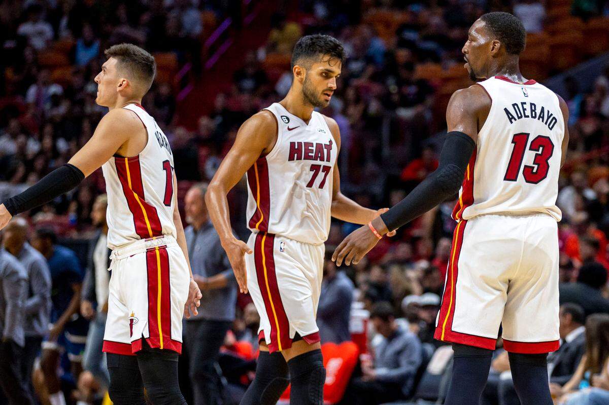 Miami Heat center Bam Adebayo (13) low-fives center Omer Yurtseven (77) during the first half of an NBA preseason basketball game against the Minnesota Timberwolves at FTX Arena in Miami on October 4, 2022.