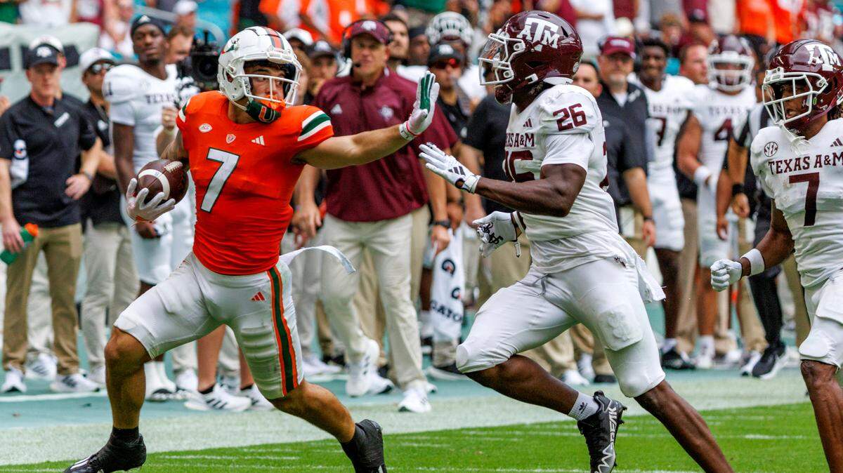 Miami Hurricanes wide receiver Xavier Restrepo (7) runs as Texas A&M Aggies defensive back Demani Richardson (26) defends during the first quarter of an NCAA non conference game at Hard Rock Stadium on Saturday, Sept. 9, 2023 in Miami Gardens, Florida.