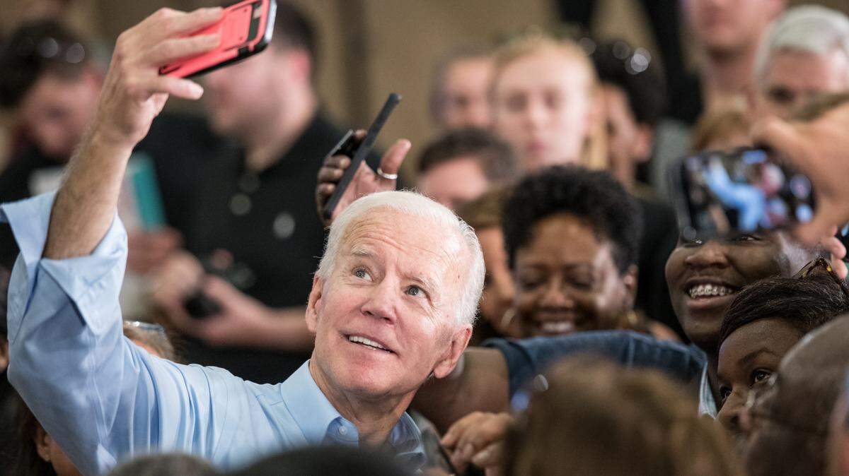 As a primary candidate in 2019, Joe Biden takes selfies with supporters at a  campaign event in Columbia, South Carolina.  