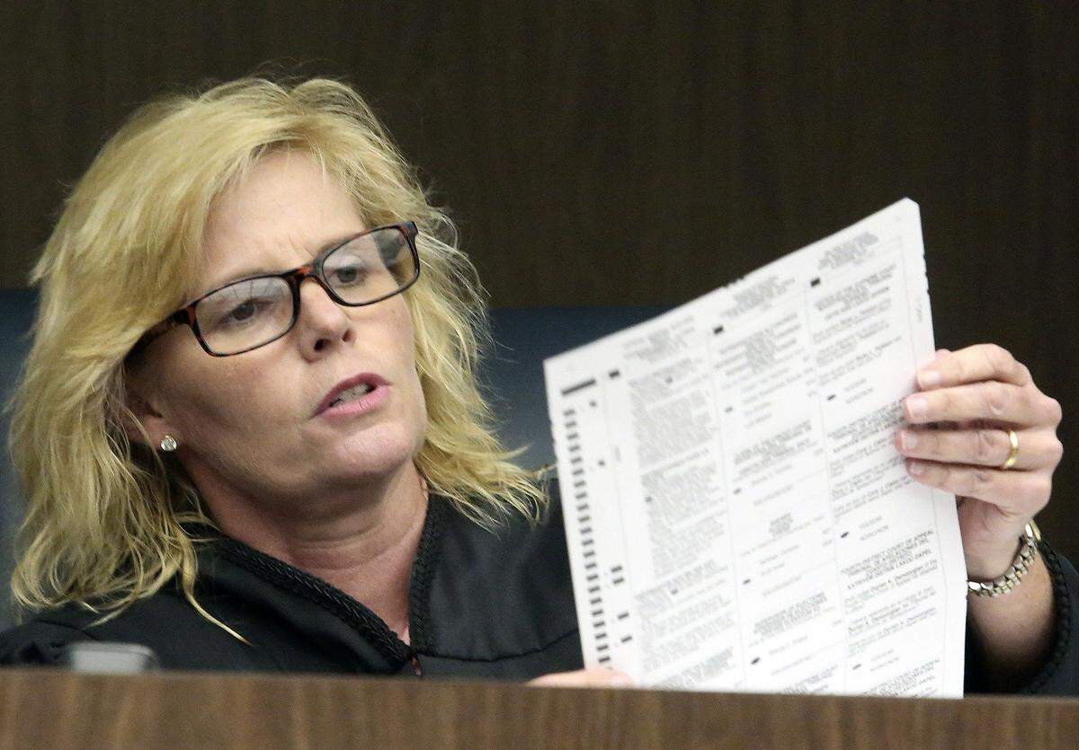 Broward Judge Carol-Lisa Phillips scrutinizes a ballot during a court hearing in 2016 in the case of some Broward County ballots missing the medical marijuana question.