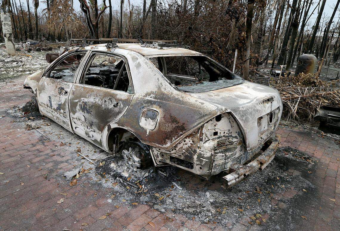 A burned car at the house owned by Chris Arsenault in Big Pine Key.