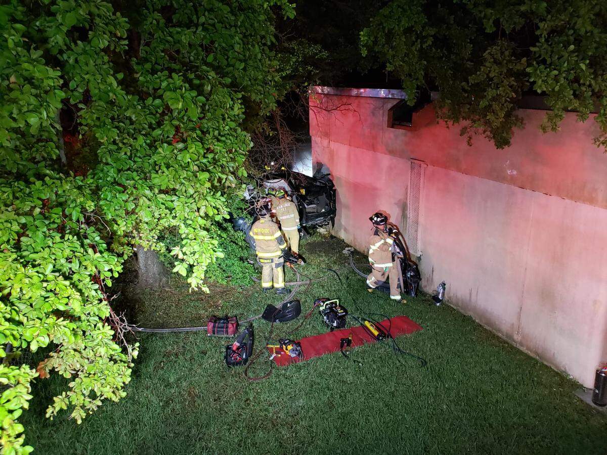 Miami-Dade Fire Rescue crews work to remove a passenger from an SUV that crashed into the Dr. Henry Mach West Little River K-8 Center on Northwest 84th Street and 24th Avenue Saturday morning, Nov. 16, 2019.