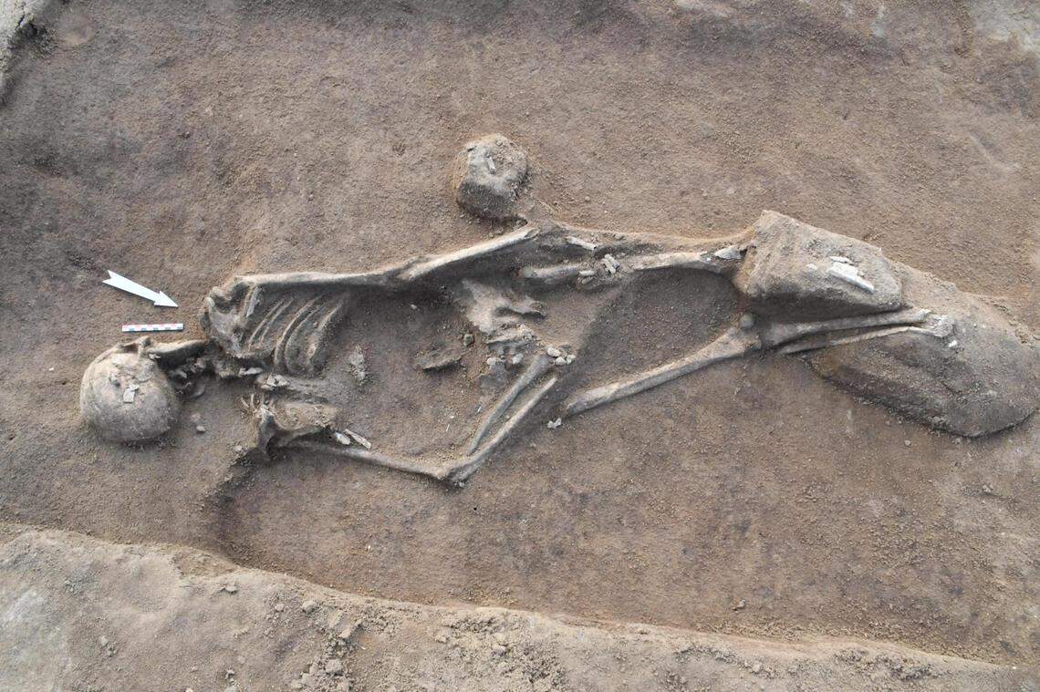 One set of human remains was buried face down with their arms behind their back, archaeologists said.