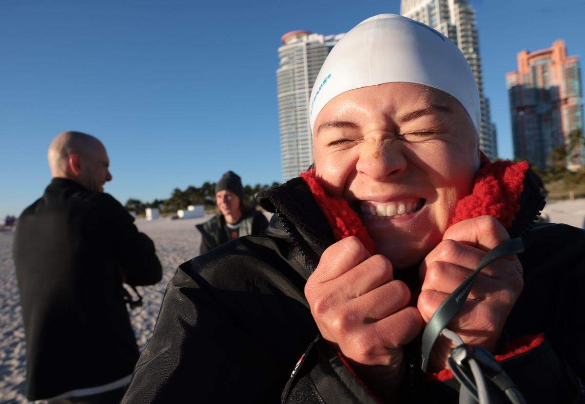 Fanny Kuhn, 32, right, visiting from Sweden, braced herself along with members of the Dolphins and Rainbows swimming clubs for an early morning swim in Miami Beach on Jan. 30, 2022, when temperatures hit the low 40s. Another cold front is expected Sunday morning, March 13, 2022, but temperatures won’t be as low. More like the 50s but there will be a wind chill factor to contend with.