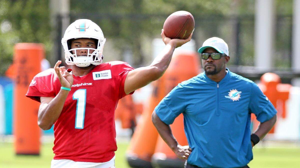 Miami Dolphins quarterback Tua Tagovailoa (1) and coach Brian Flores during training camp at the new training camp facility at Hard Rock Stadium in Miami Gardens, Florida, August 4, 2021.
