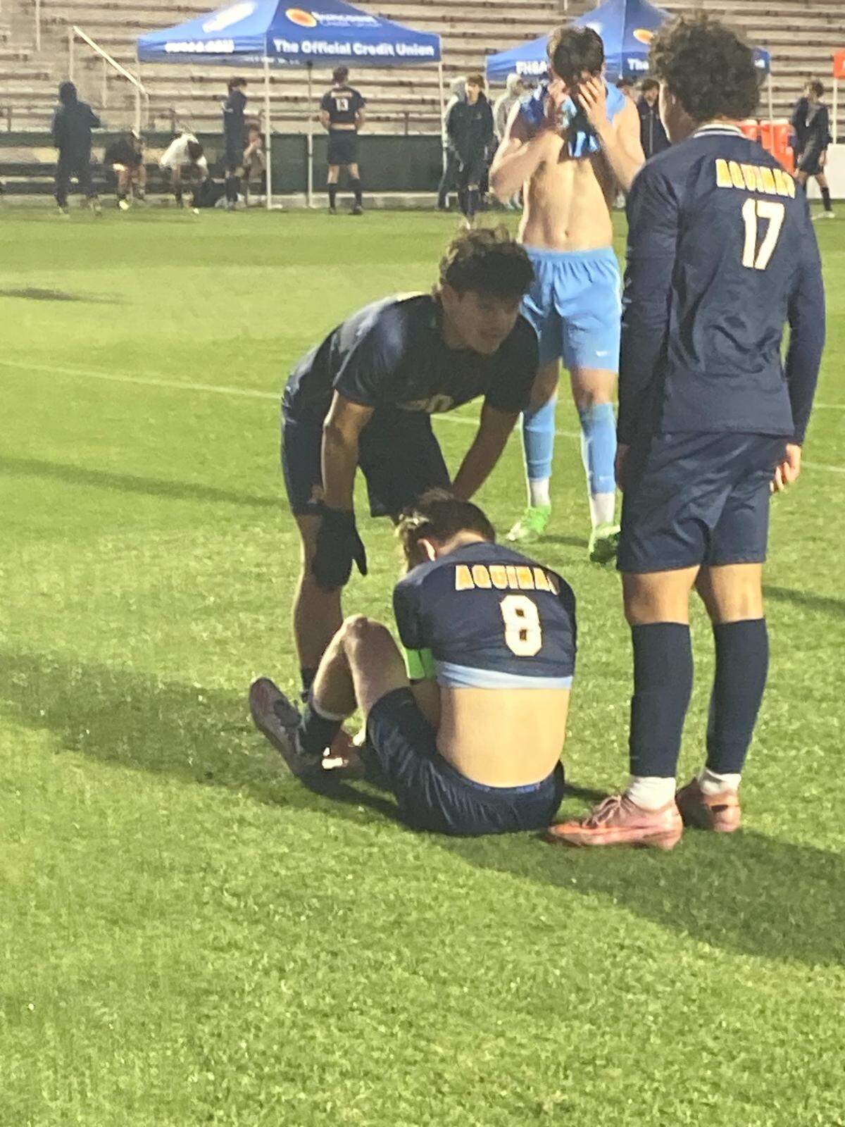 St. Thomas Aquinas players Felipe Tobon (left) and Luca Amarini (17) try and console teammate Ethan See after his penalty kick shot went over the net ending Monday’s state semifinal penalty kick loss to Land O’Lakes Sunlake.