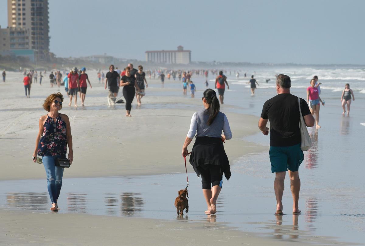 People flocked to Jacksonville Beach on Friday, April 17, 2020, immediately after it reopened at 5 p.m. Gov. Ron DeSantis gave the green light for some beaches and parks to reopen if it can be done safely and respecting social distancing guidelines.