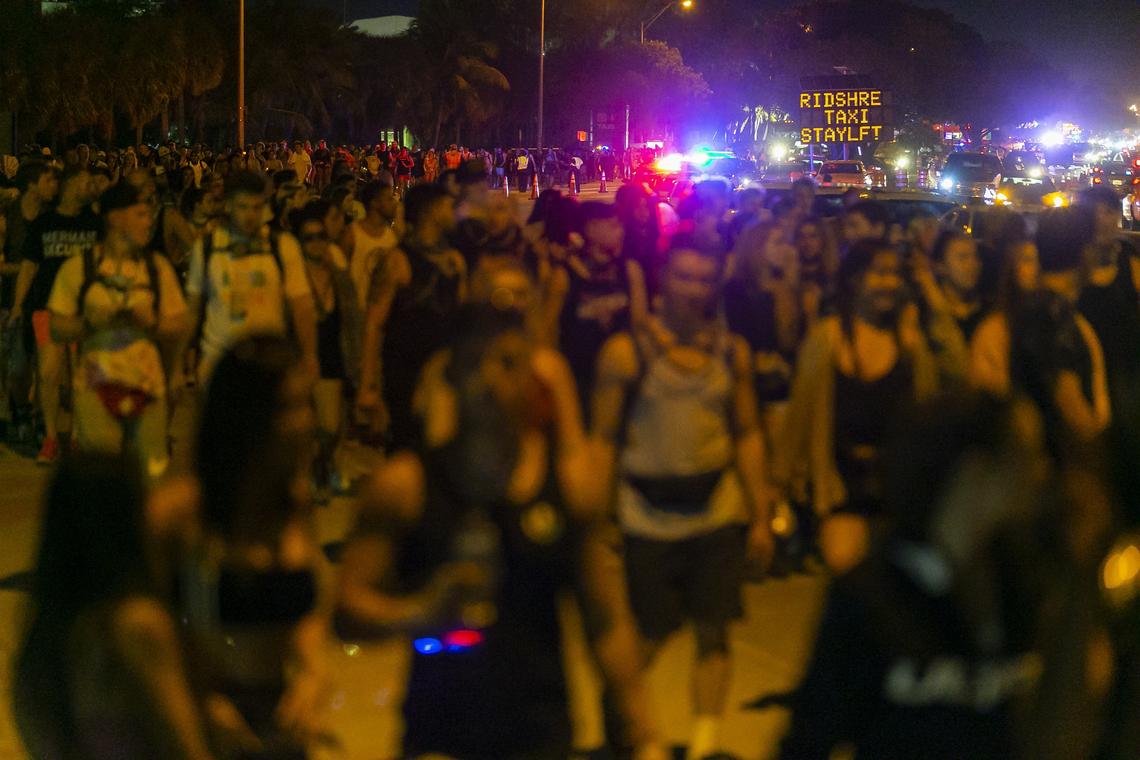 Thousands of festival goers make their way toward the Rickenbacker Causeway after leaving the second day of the 2019 Ultra Music Festival in Virginia Key, Florida on Sunday, March 31, 2019.