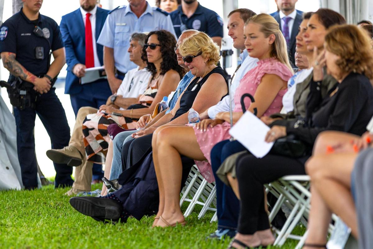 People react from their seats during the Second Annual Remembrance Ceremony of the Champlain Towers South building collapse at Veterans Park on Saturday, June 24, 2023, in Surfside, Florida.