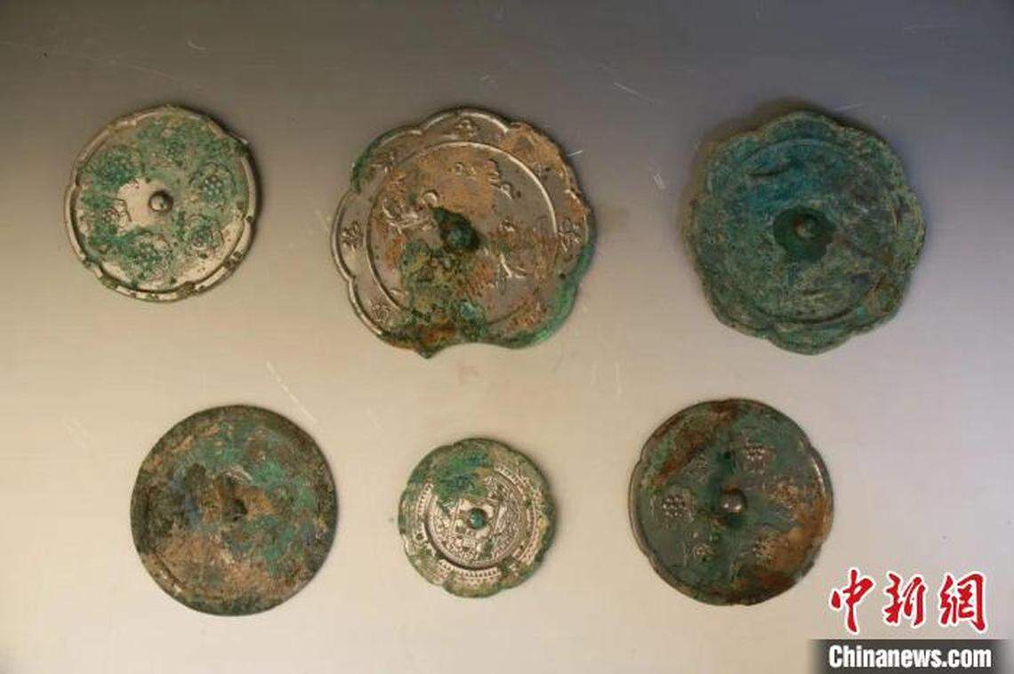 Some bronze mirrors uncovered at the cemetery.